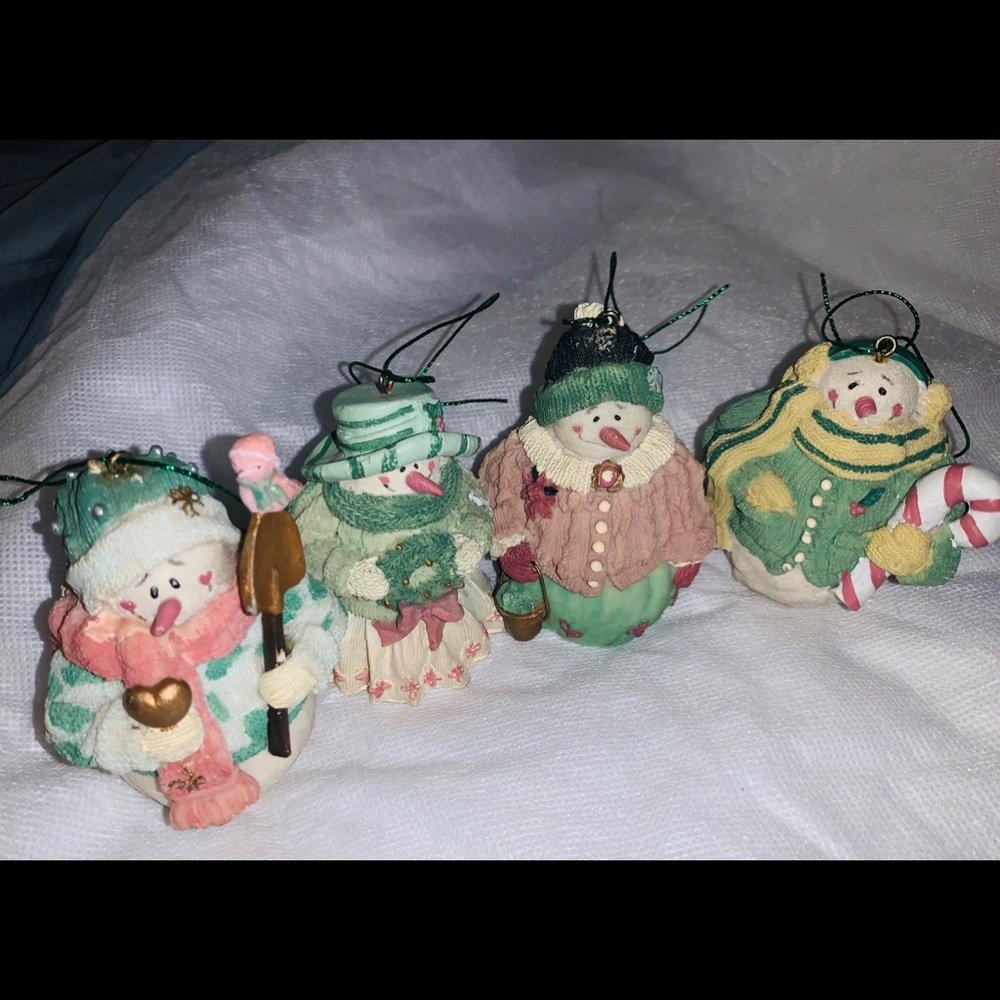 Four Snowman Christmas ornaments.